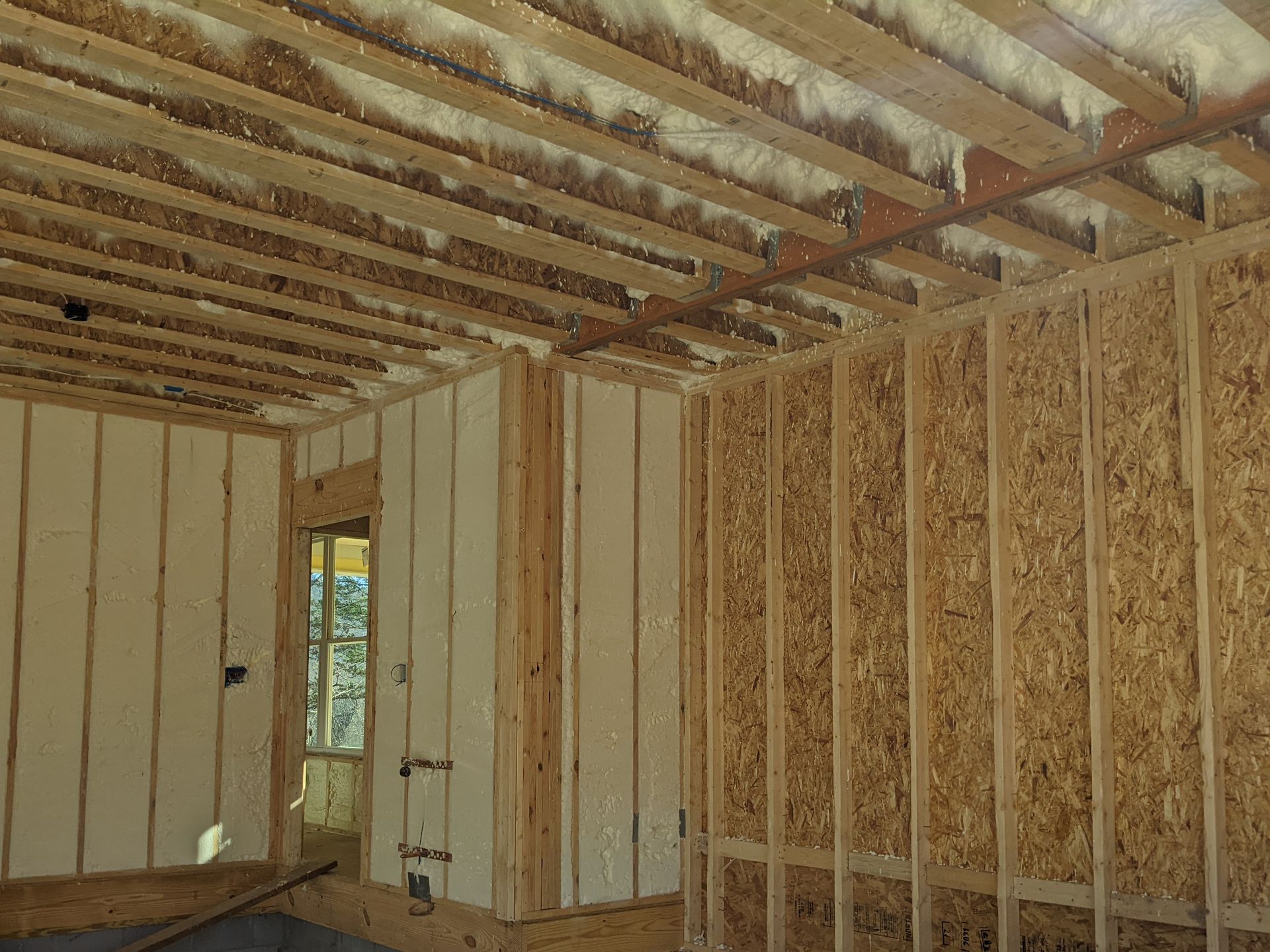 A room with wooden walls and a ceiling that is being built.