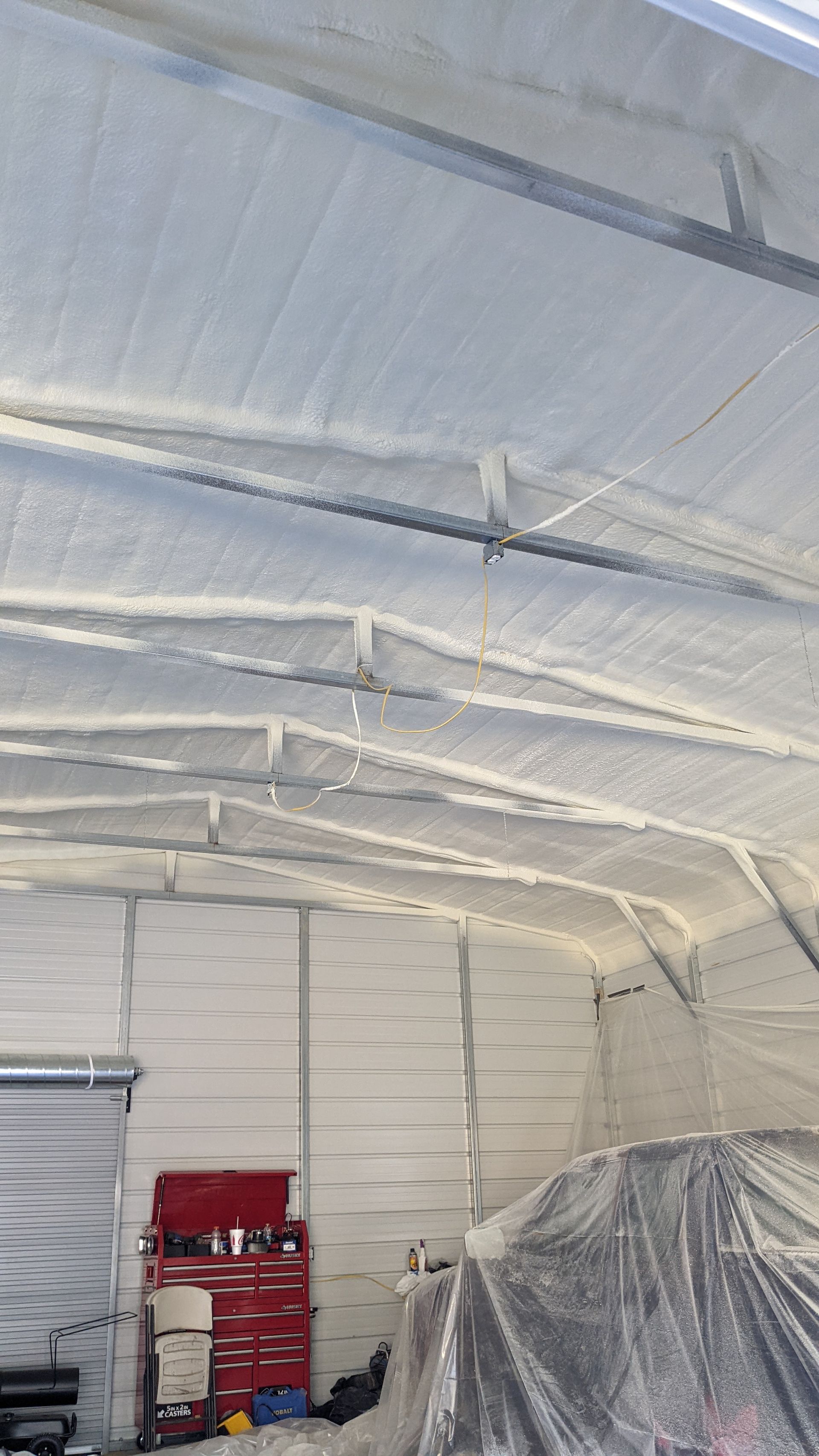 A garage with a lot of foam on the ceiling and walls.