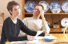 Unhappy couple looking at their tax papers