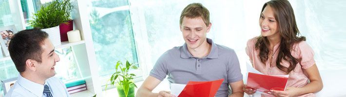 Insurance agent having a meeting with a young family at home