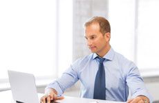 Picture of smiling businessman working in office