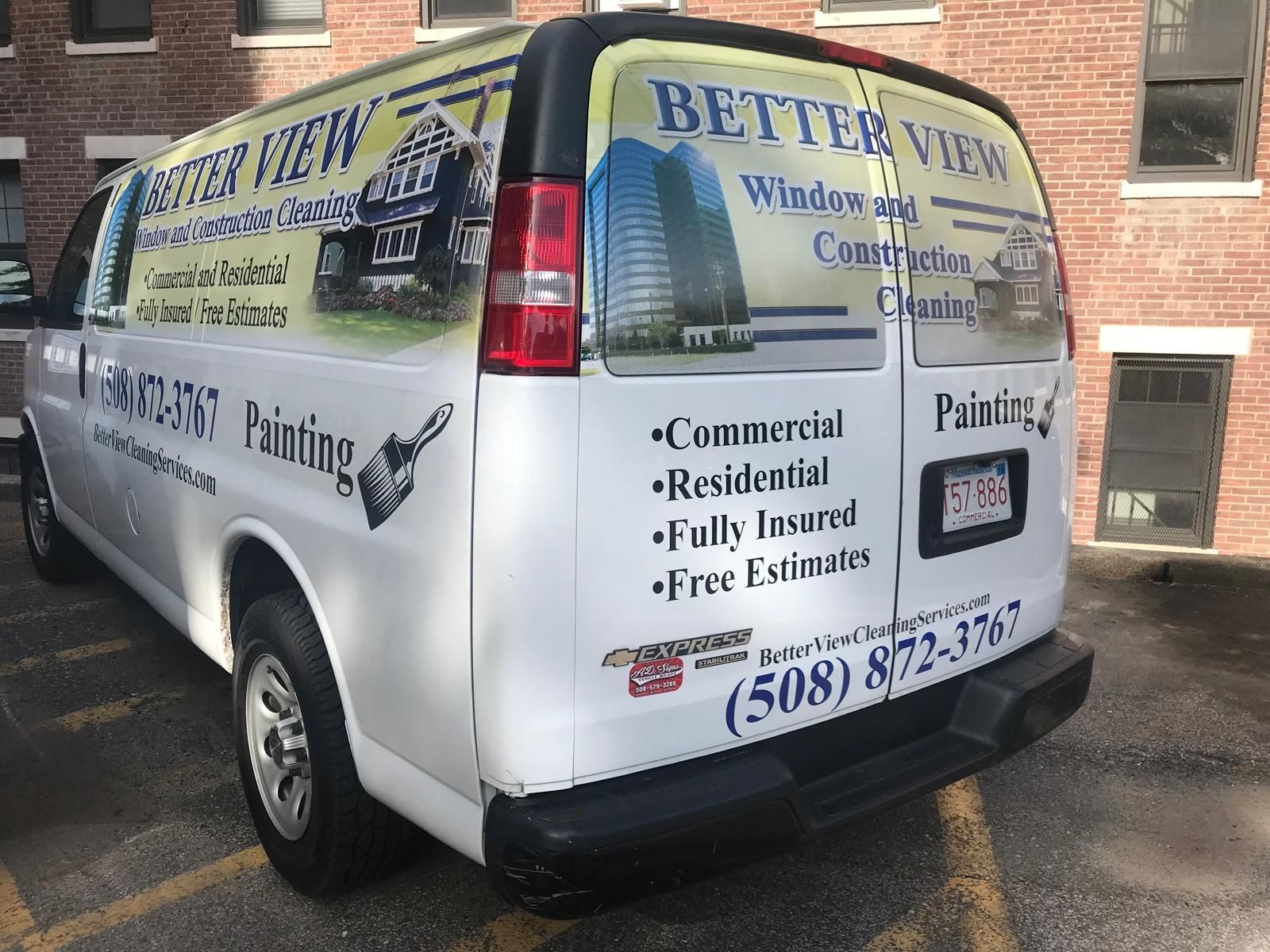 White van with “Better View Window Cleaning” and “Painting” business signage parked by a brick building.