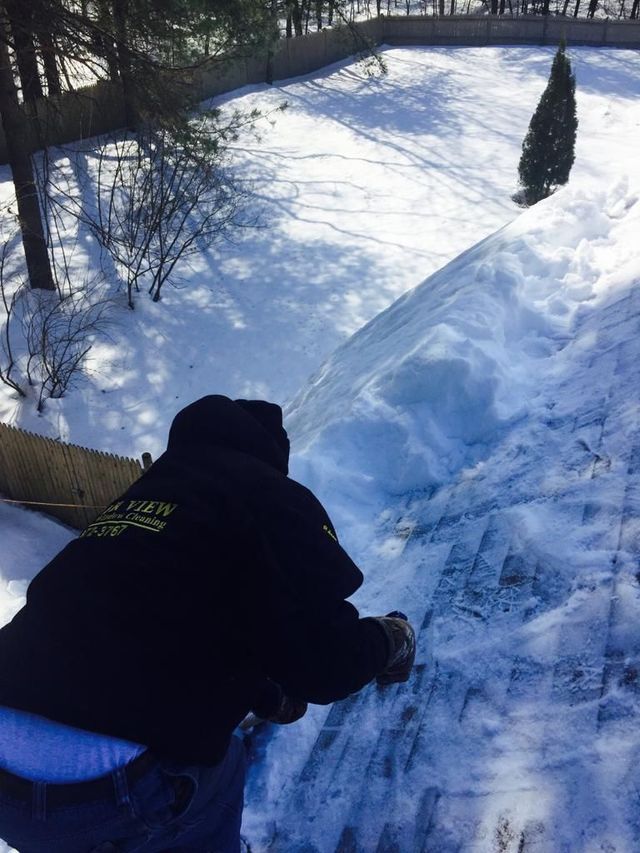 Person sledding down a snowy hill on a bright winter day
