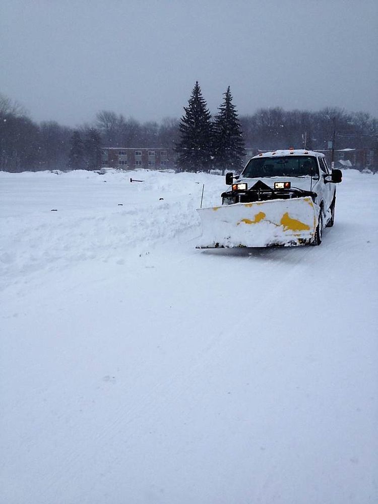 Snowplow clearing a snowy road in a winter landscape