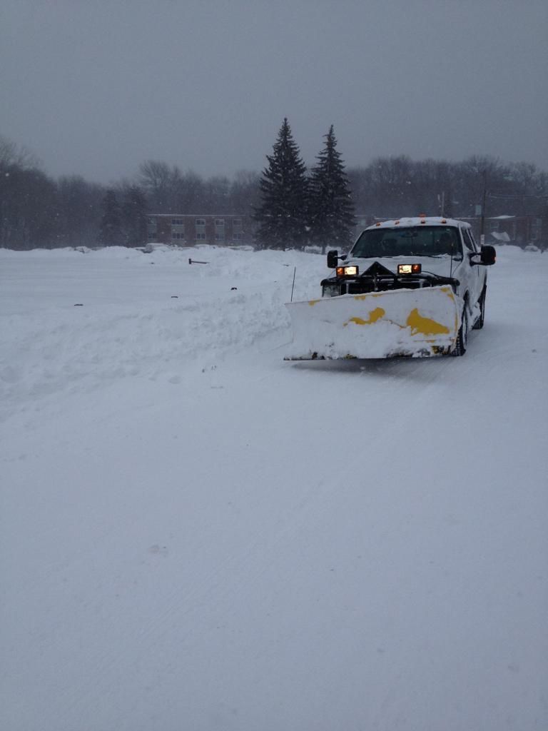 Snowplow clearing a snowy road in a winter landscape