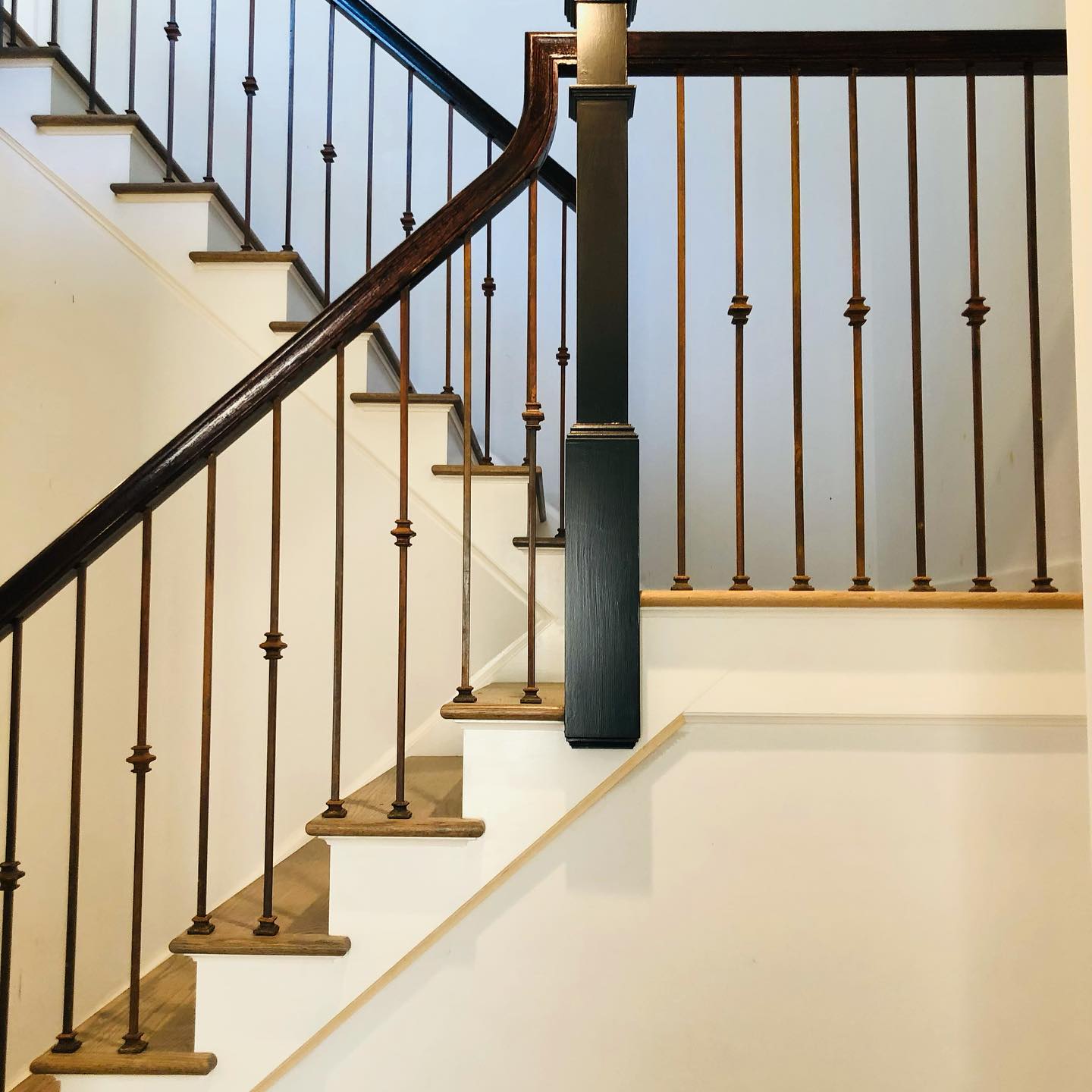 A staircase with a black railing and wooden steps