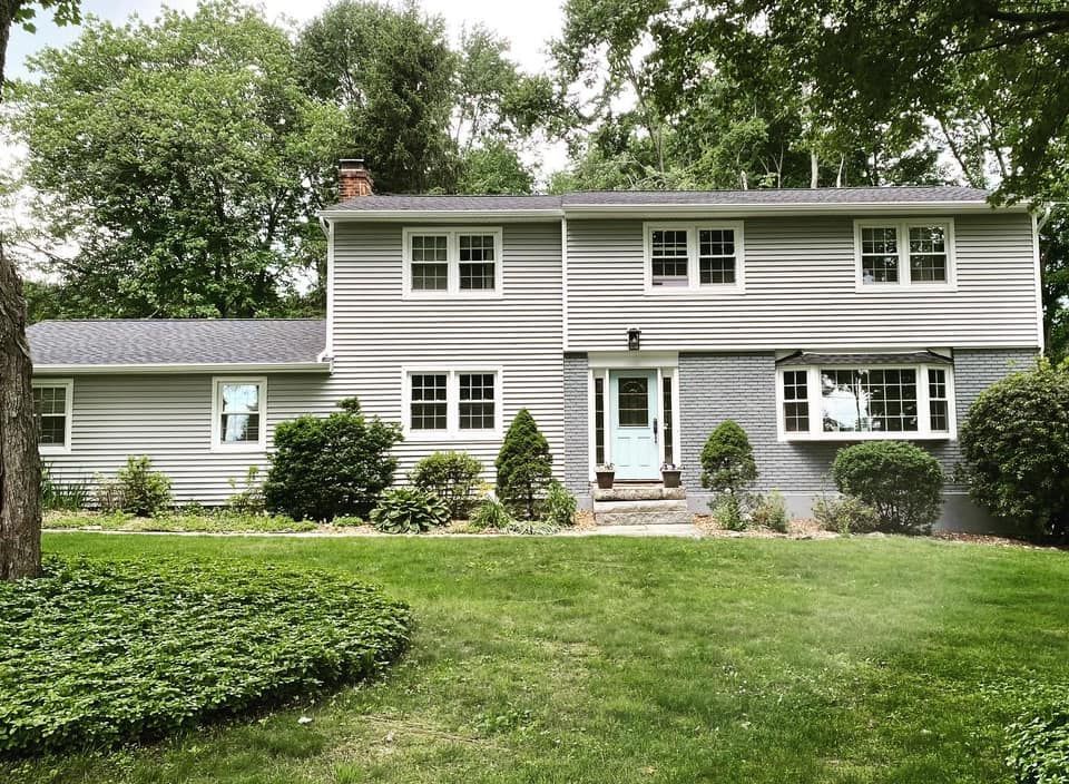 A large house with a lush green lawn in front of it.