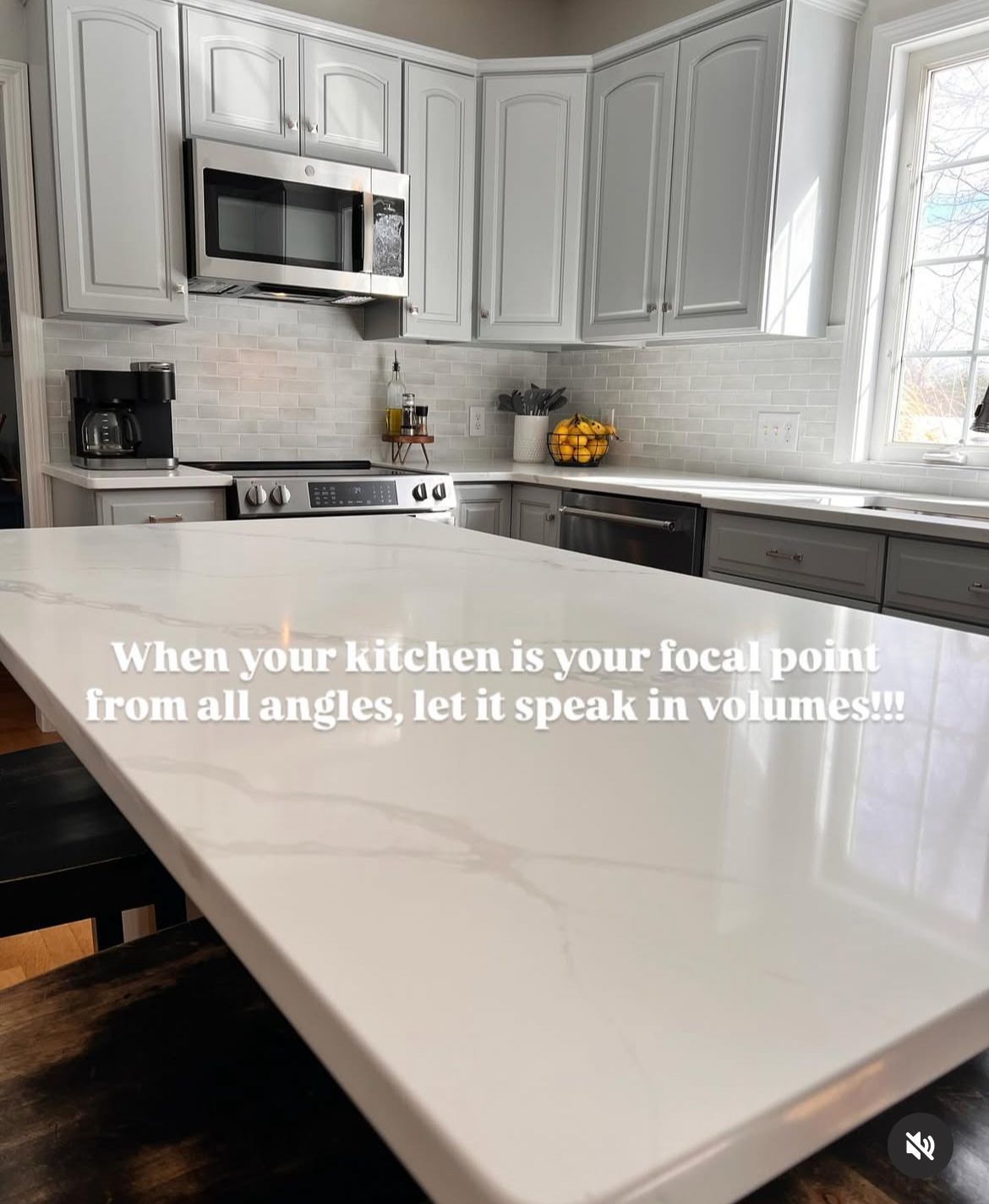 A kitchen with white cabinets and a white counter top.