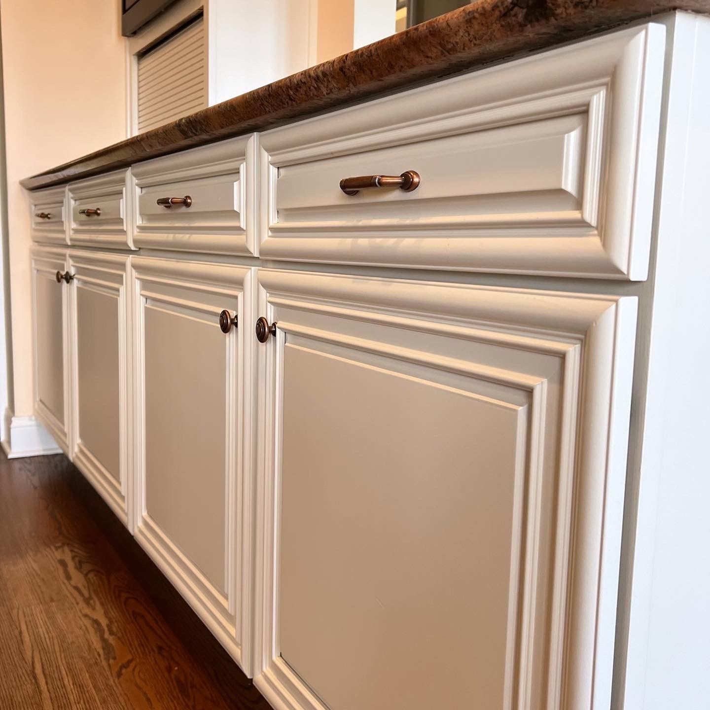 A kitchen with white cabinets and a granite counter top