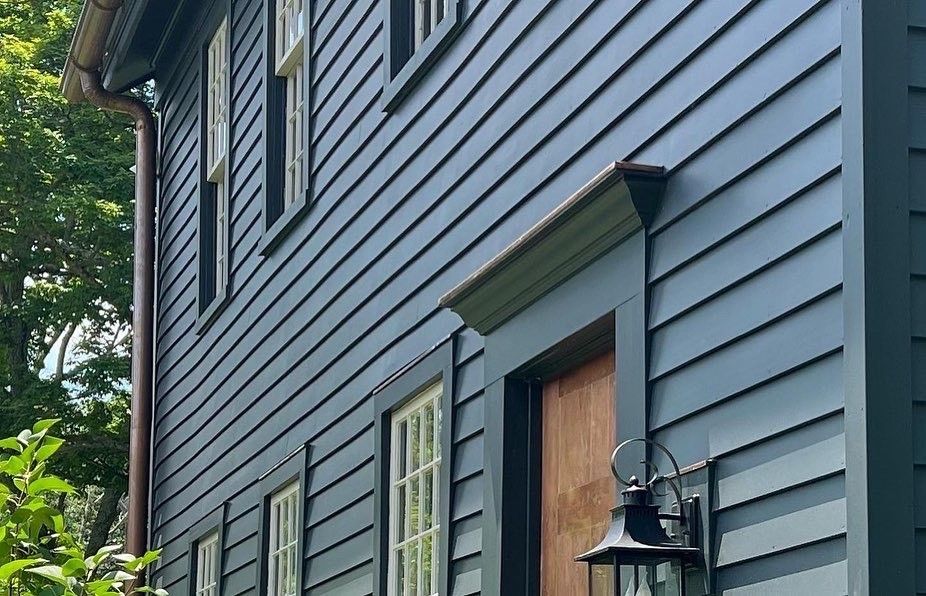A blue house with a lantern on the side of it