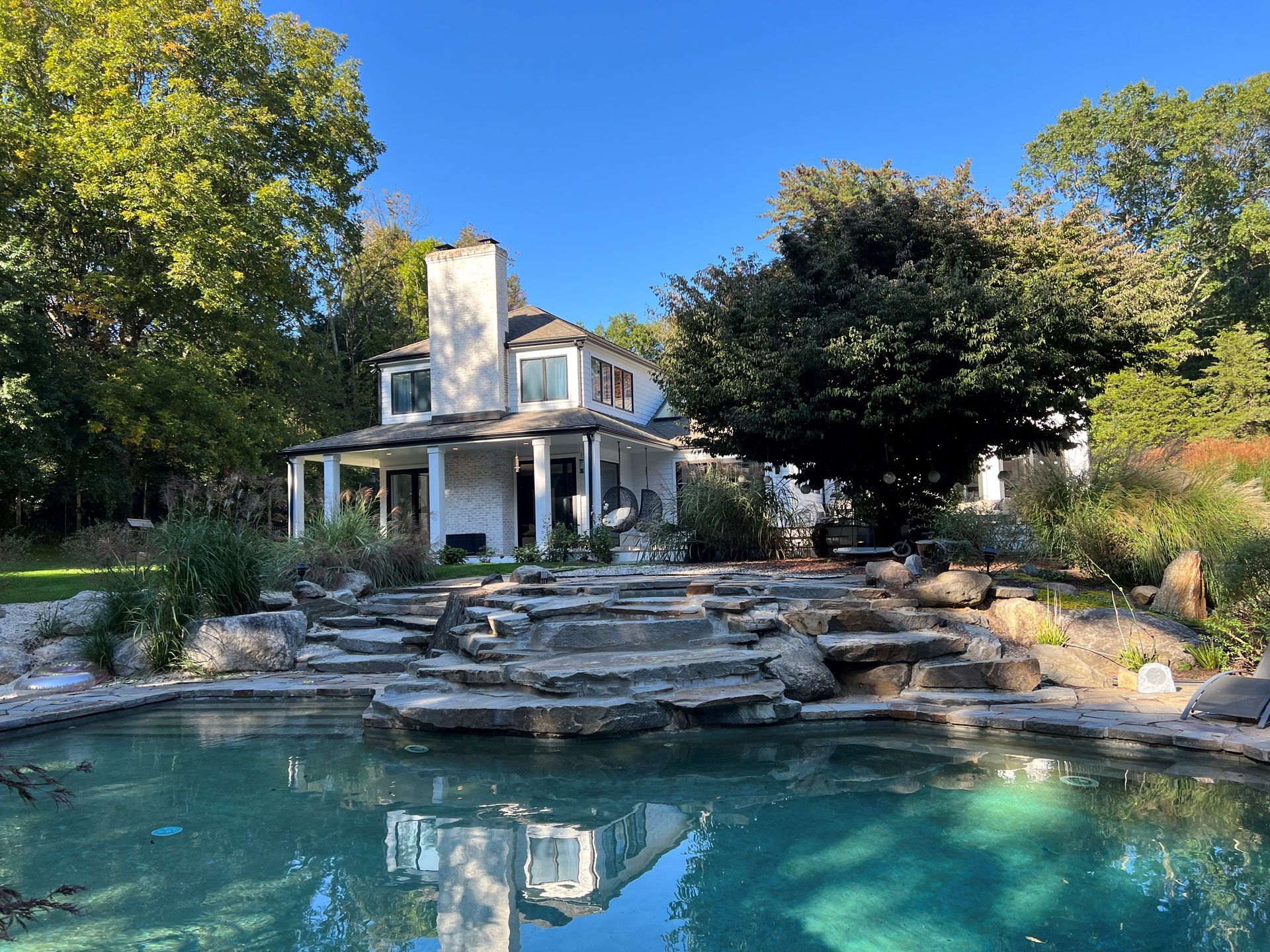 A large house with a swimming pool in front of it