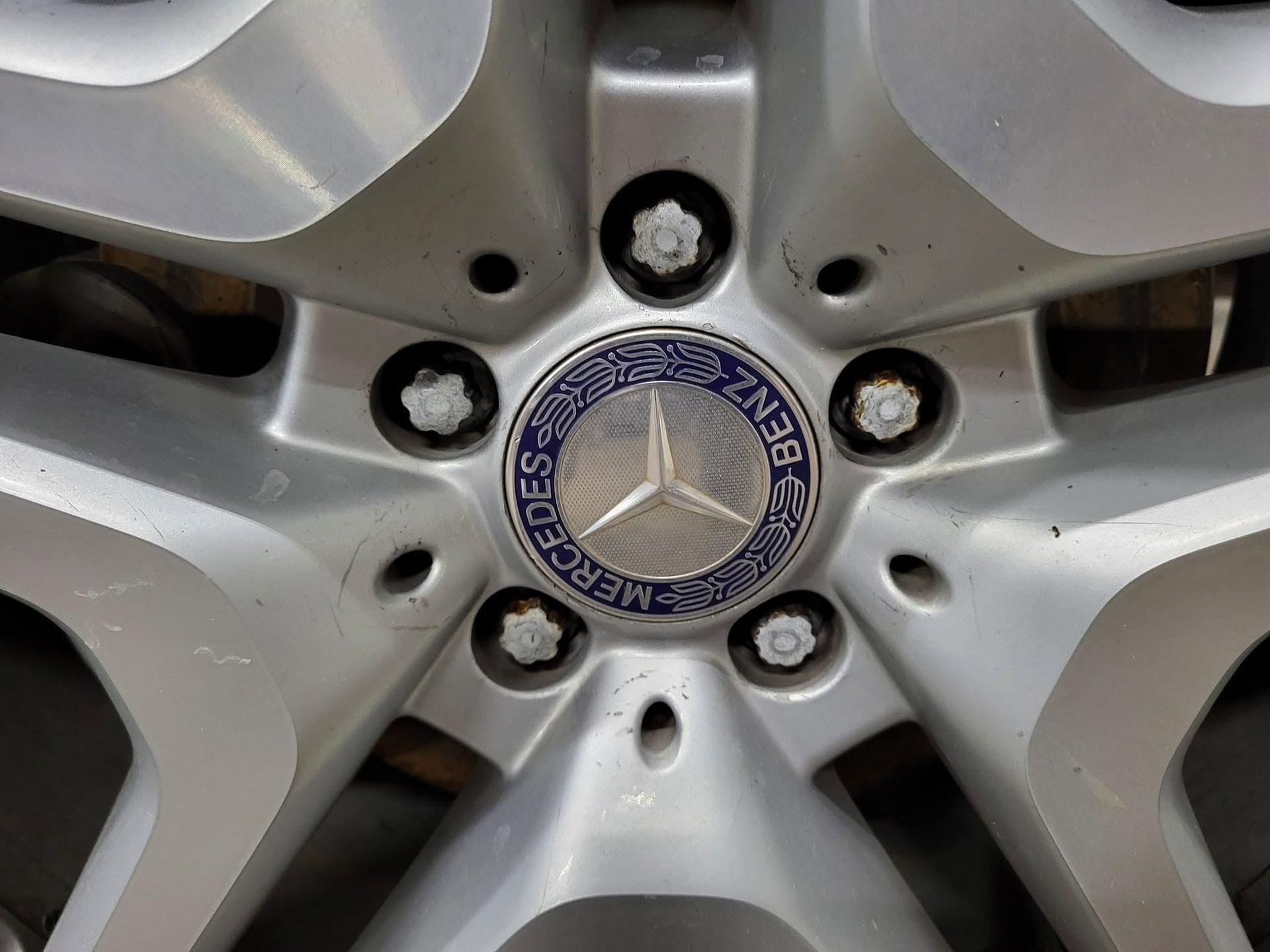 Close-up of a Mercedes-Benz alloy wheel with silver spokes and logo center cap