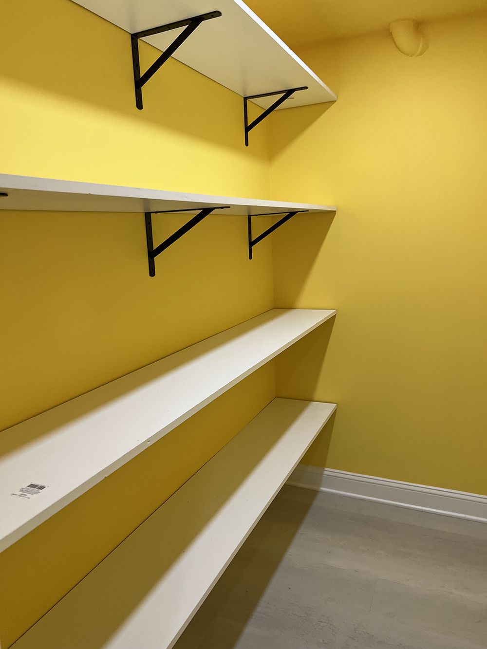 Empty shelves in a room with yellow walls