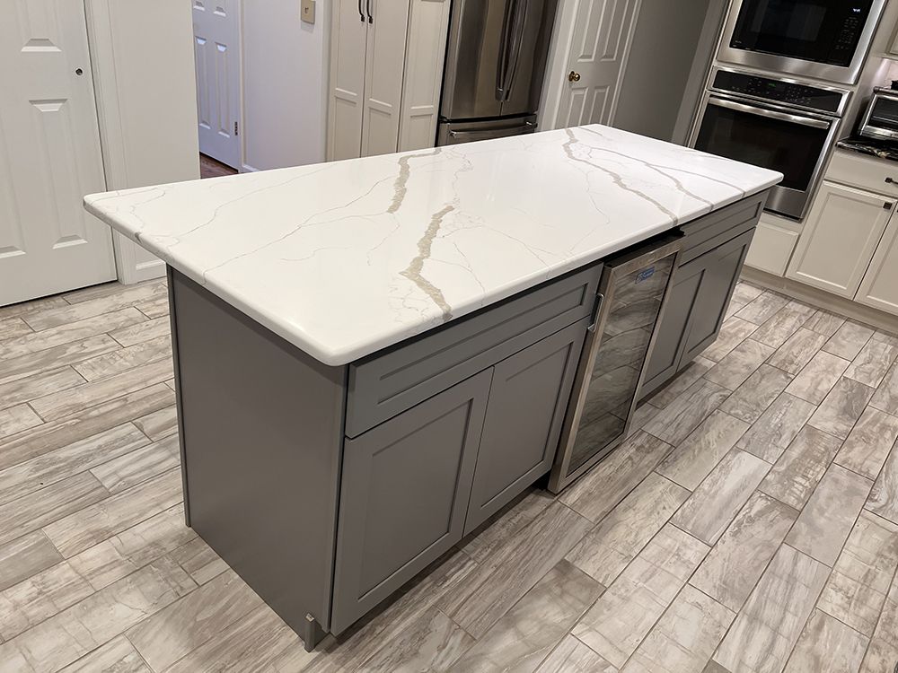 There is a large island in the middle of the kitchen.