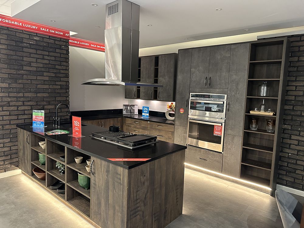A kitchen with a large island in the middle and a stove top oven.