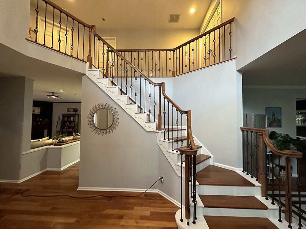 A staircase in a house with a mirror on the wall