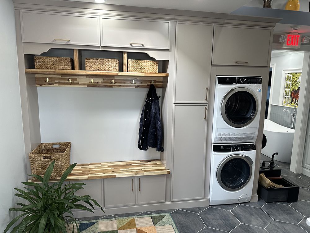A laundry room with a washer and dryer stacked on top of each other.