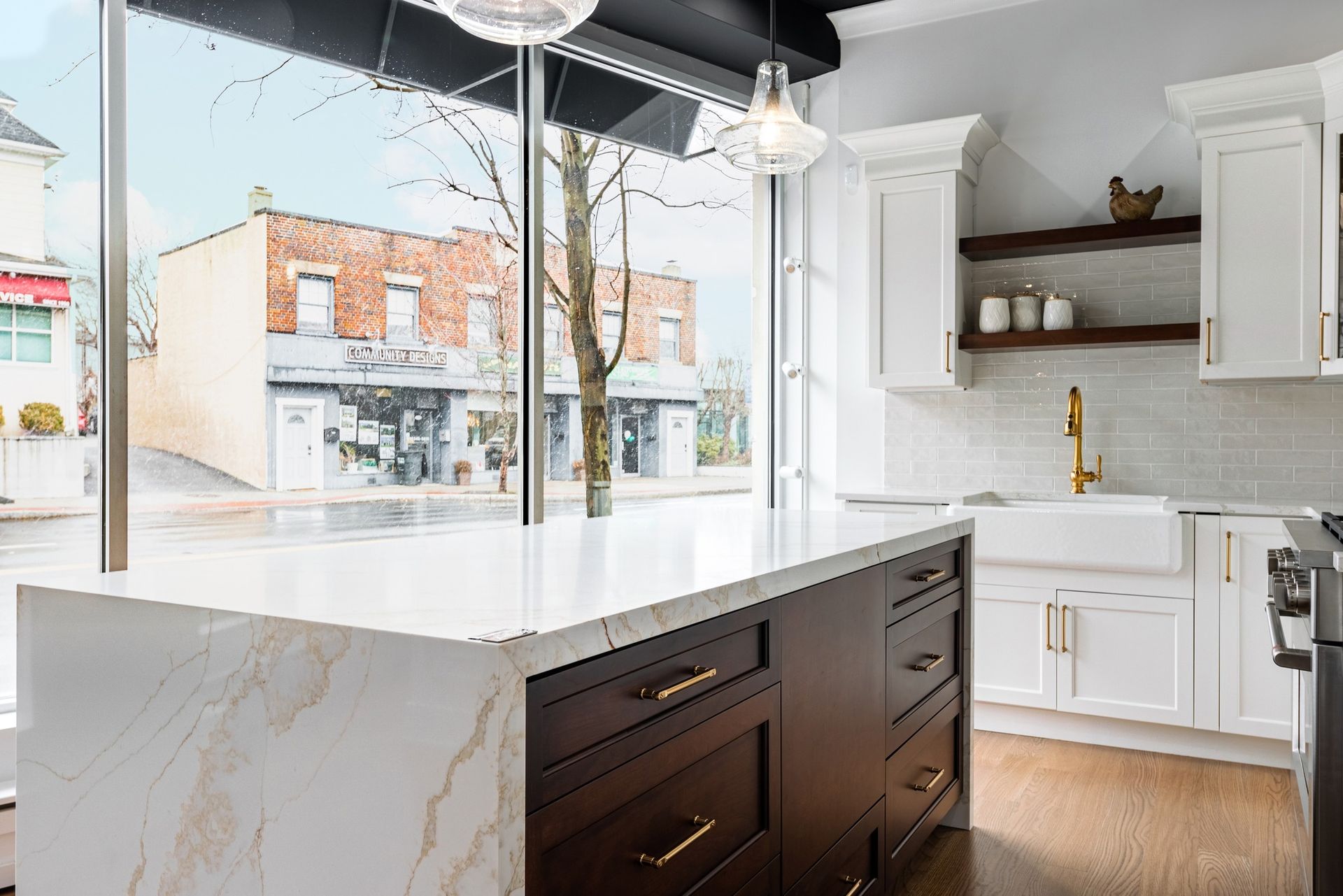 A kitchen with a large island in the middle of it and a large window.