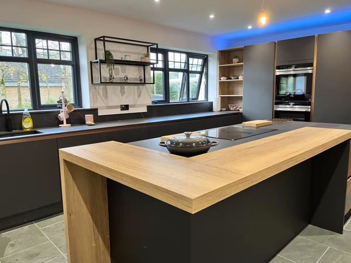 A kitchen with a large island and a wooden counter top.