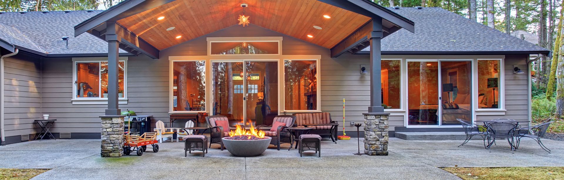 A large house with a fire pit in front of it.