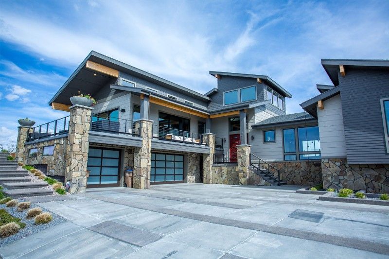 A large house with a lot of windows and stairs in front of it.