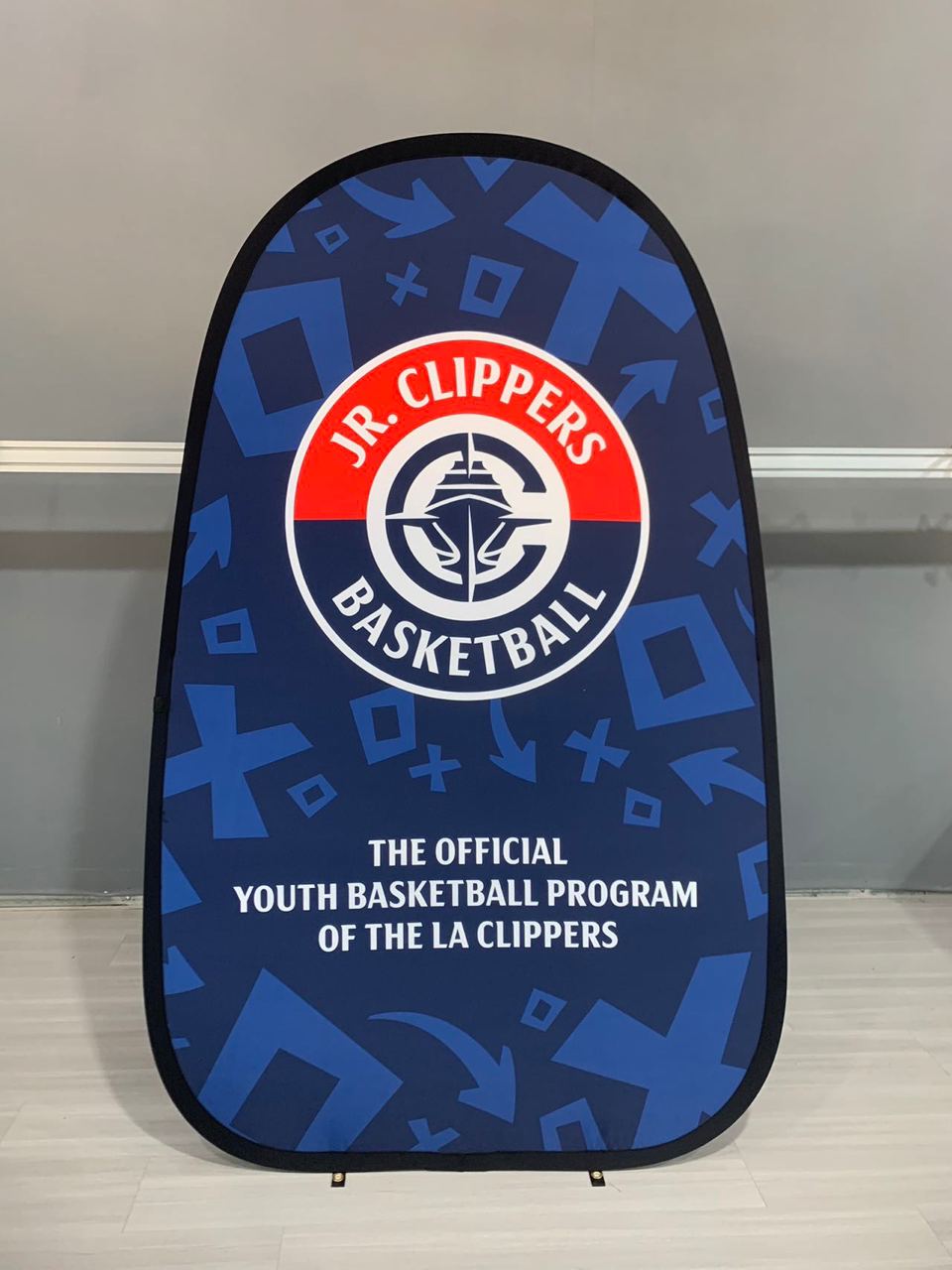 Jr. Clippers Basketball pop-up banner with team logo and tagline, blue background with white and red accents.