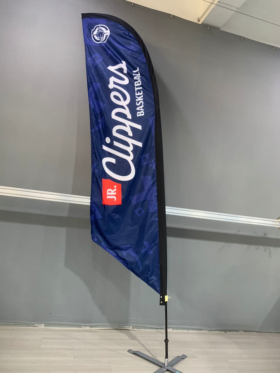 Los Angeles Clippers Jr. Basketball feather flag; blue and white on a gray wall.