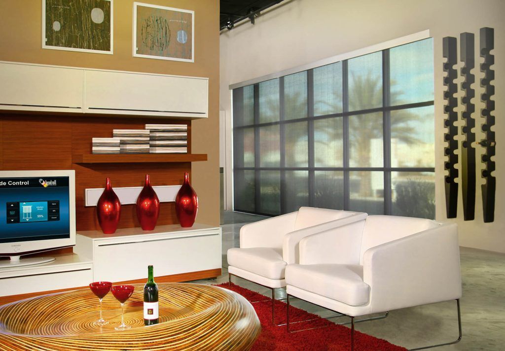A living room with a bottle of wine on a coffee table