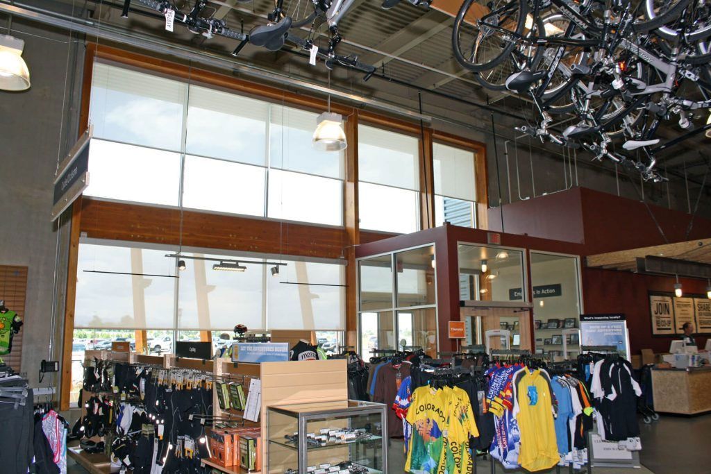A store with a bunch of shirts hanging from the ceiling