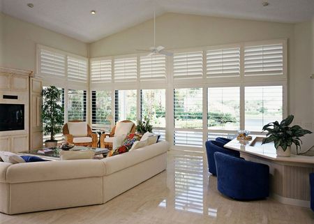 A living room with a vaulted ceiling and lots of windows