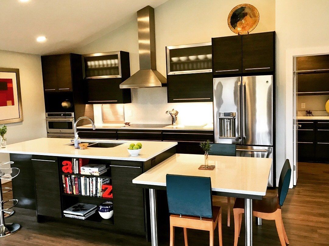 A kitchen with a table and chairs and a refrigerator