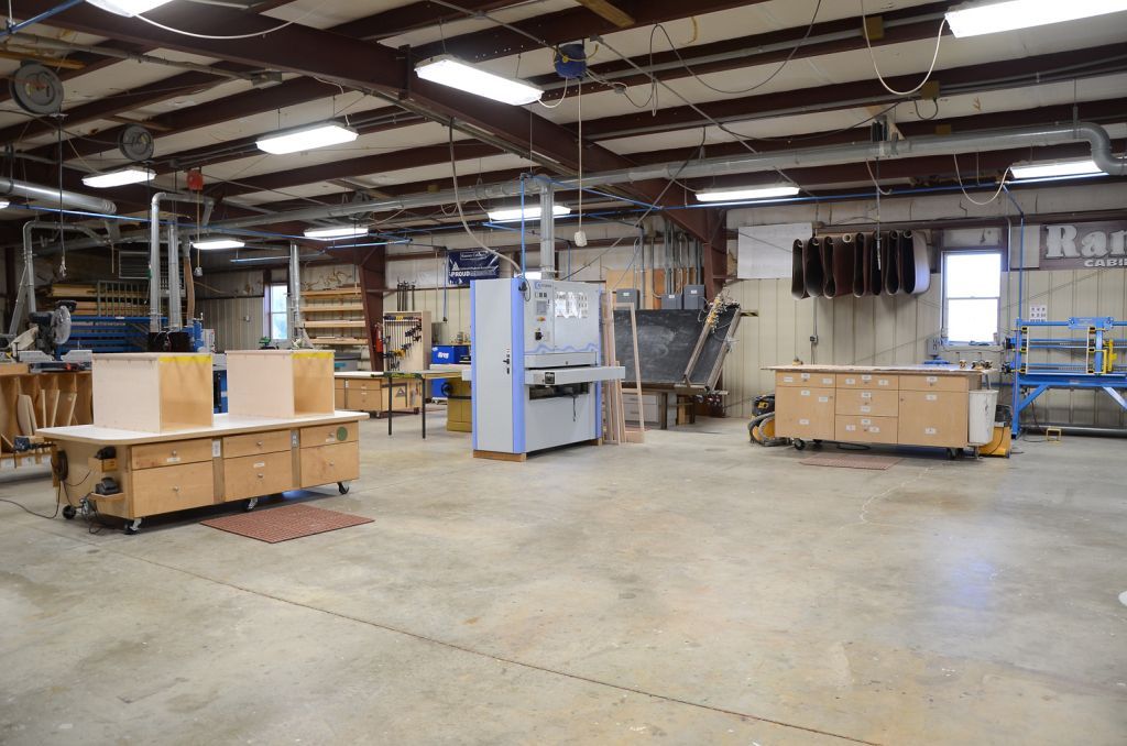 A large warehouse filled with lots of machinery and tables.