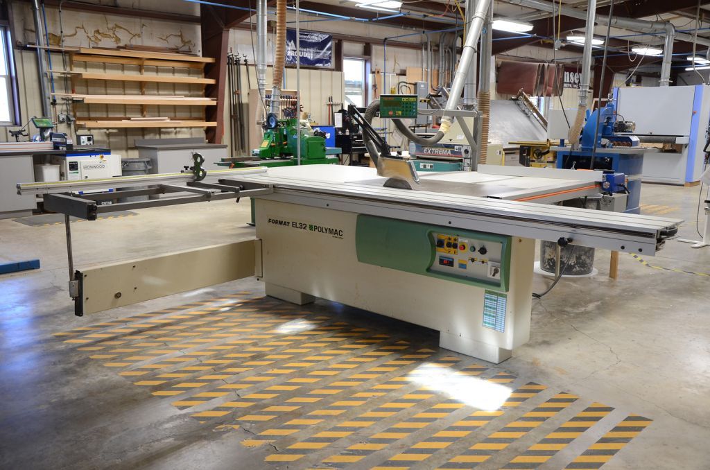 A large machine is sitting in the middle of a factory.