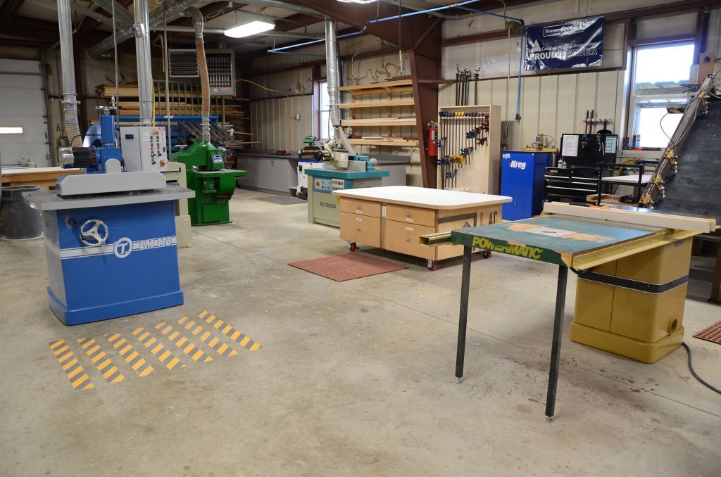 A large room with a lot of tables and machines in it