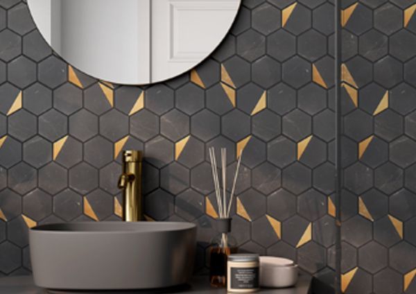 A bathroom with a sink , mirror , and honeycomb tiles.