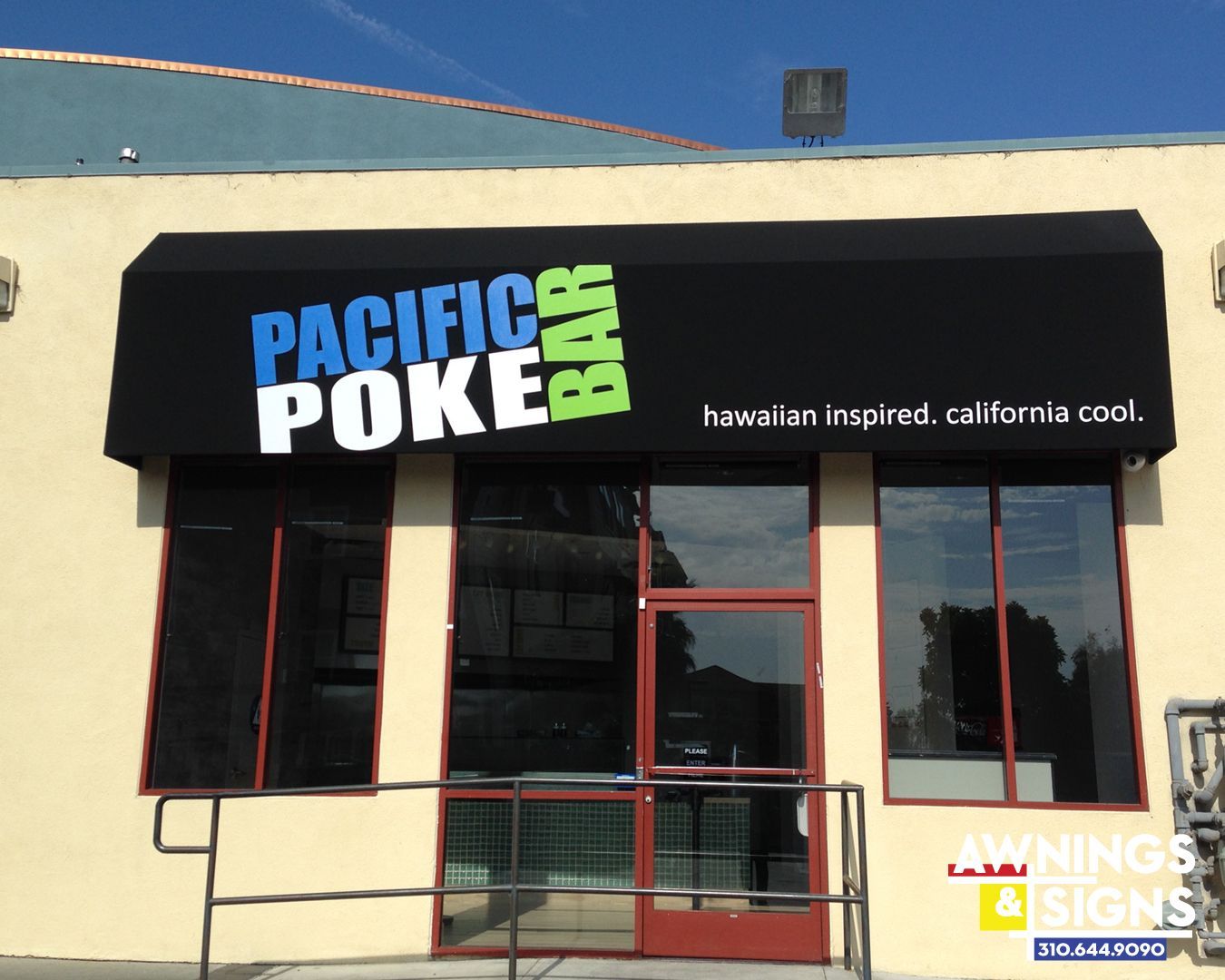 Pacific Poke Bar awning over entrance; black with blue and green text; Hawaiian inspired, California cool.