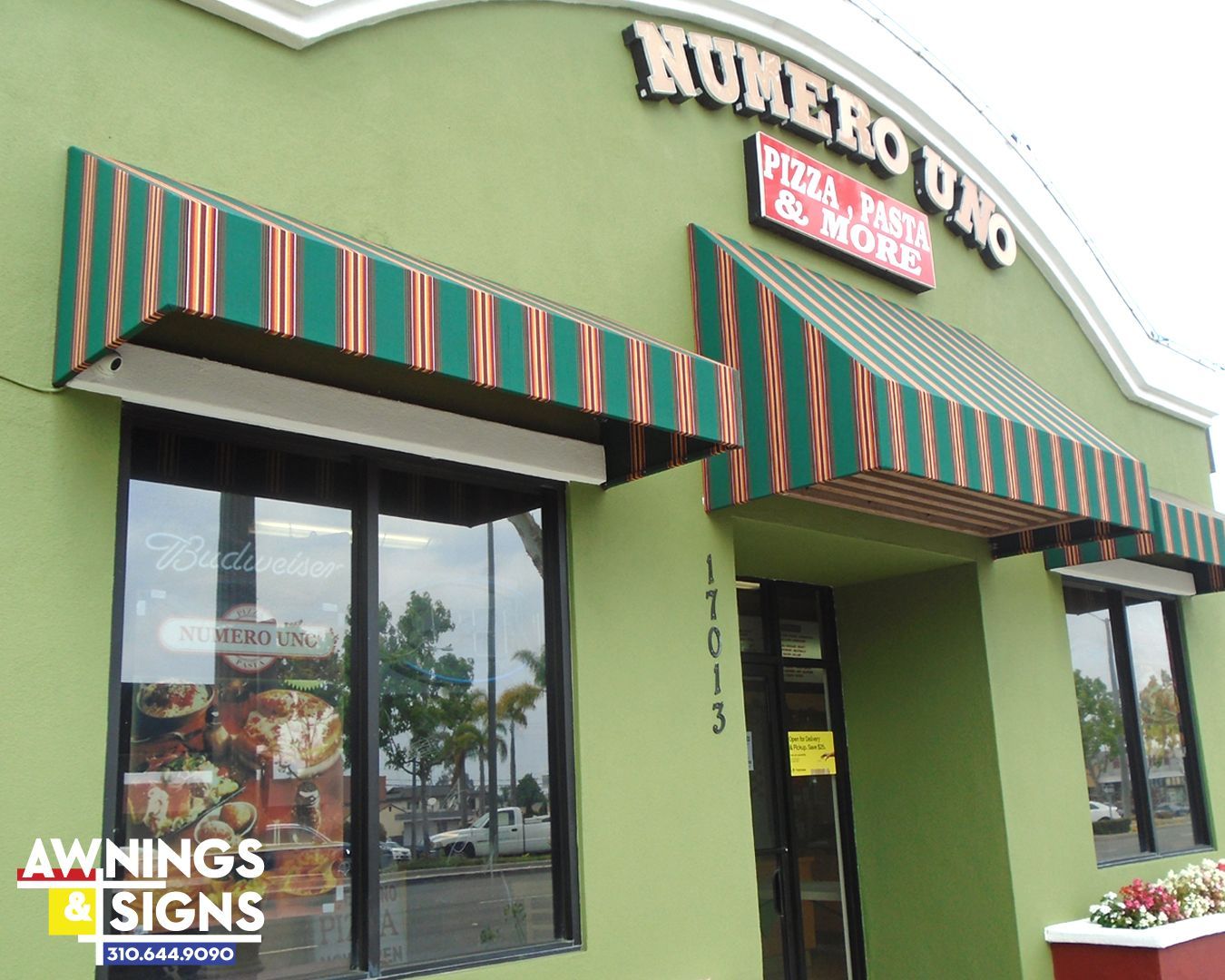 Numero Uno Pizza restaurant with green exterior, awnings, and sign.