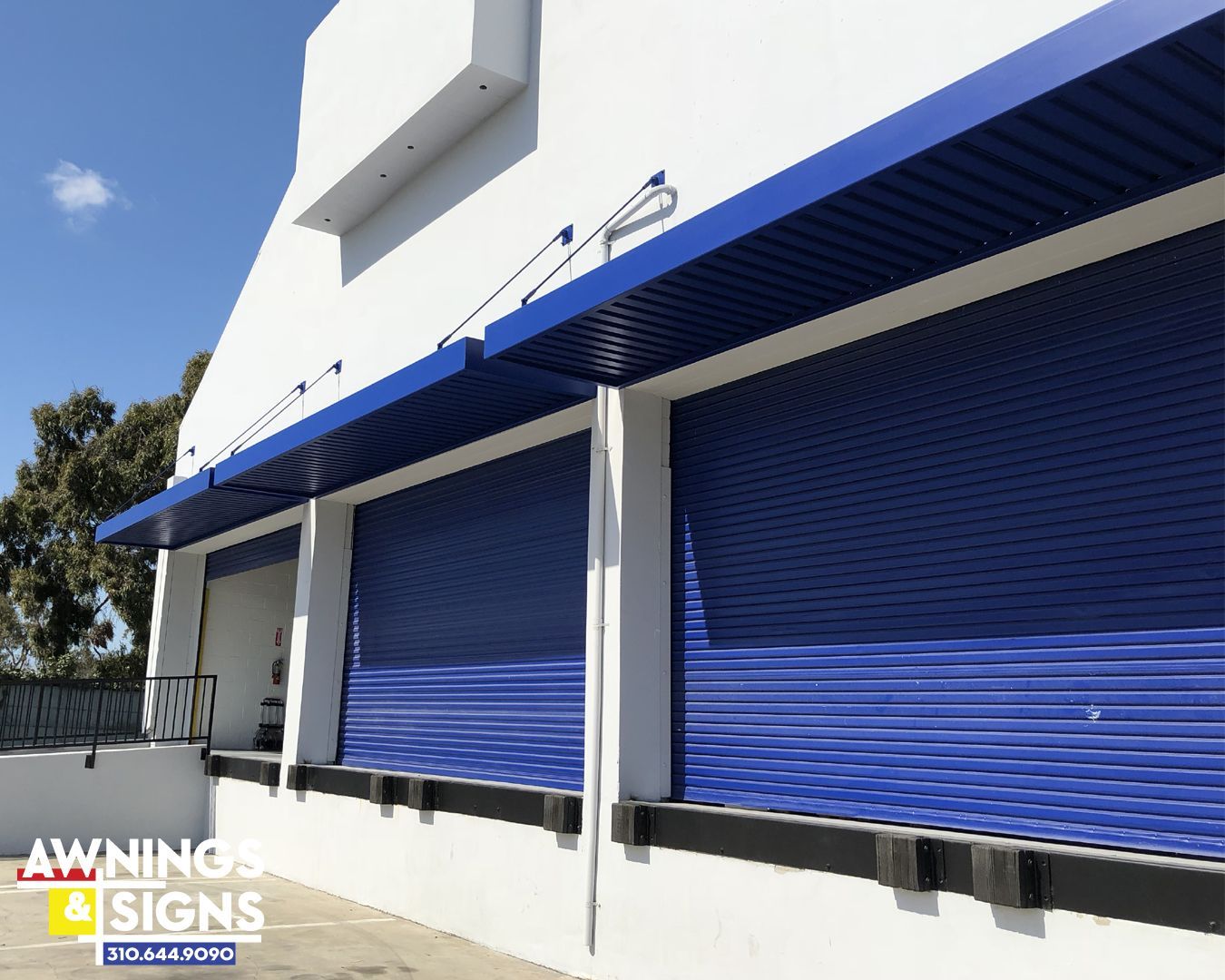 Blue roller shutters and awnings on a white building.