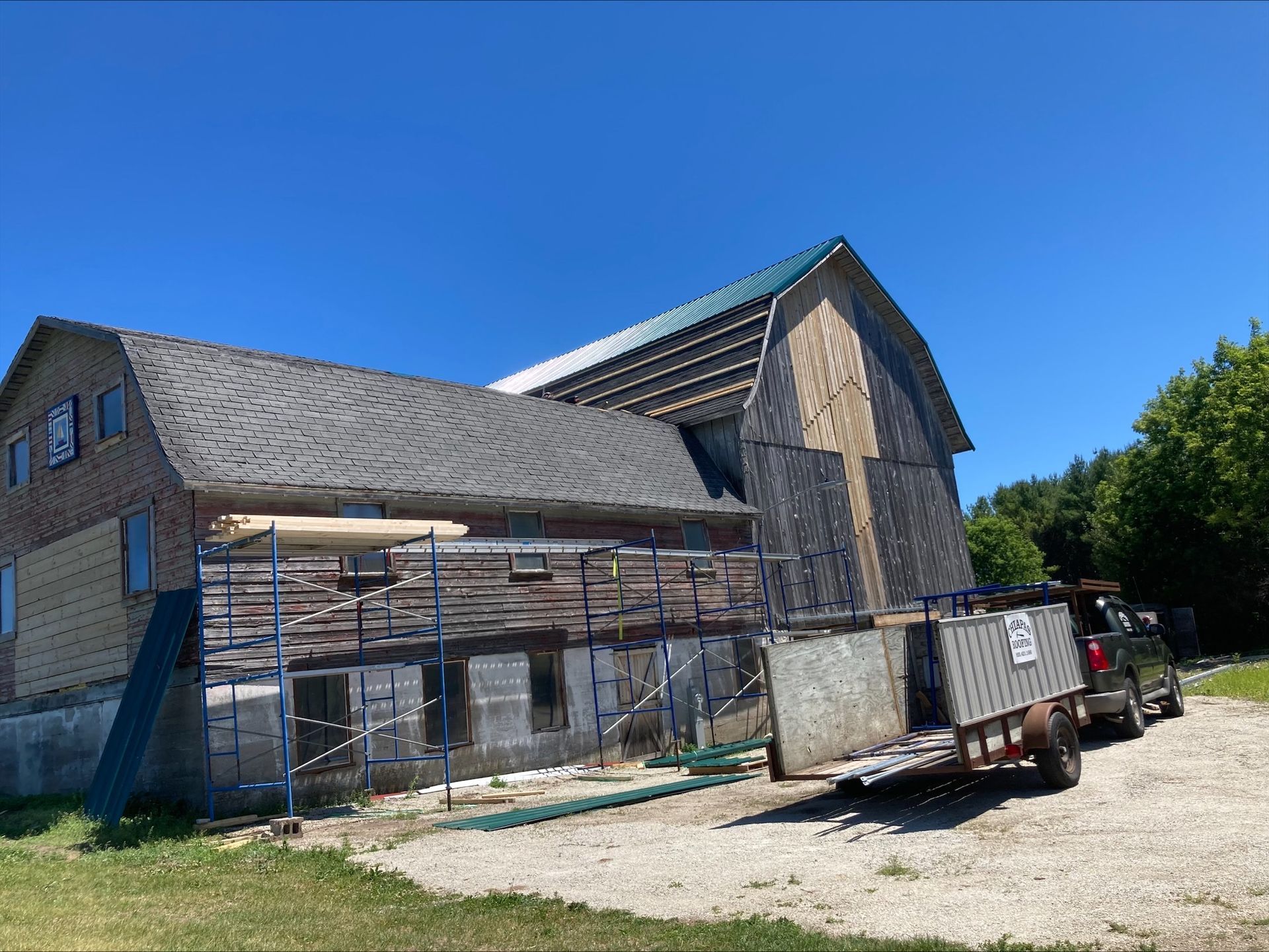 A truck is parked in front of a large building under construction.