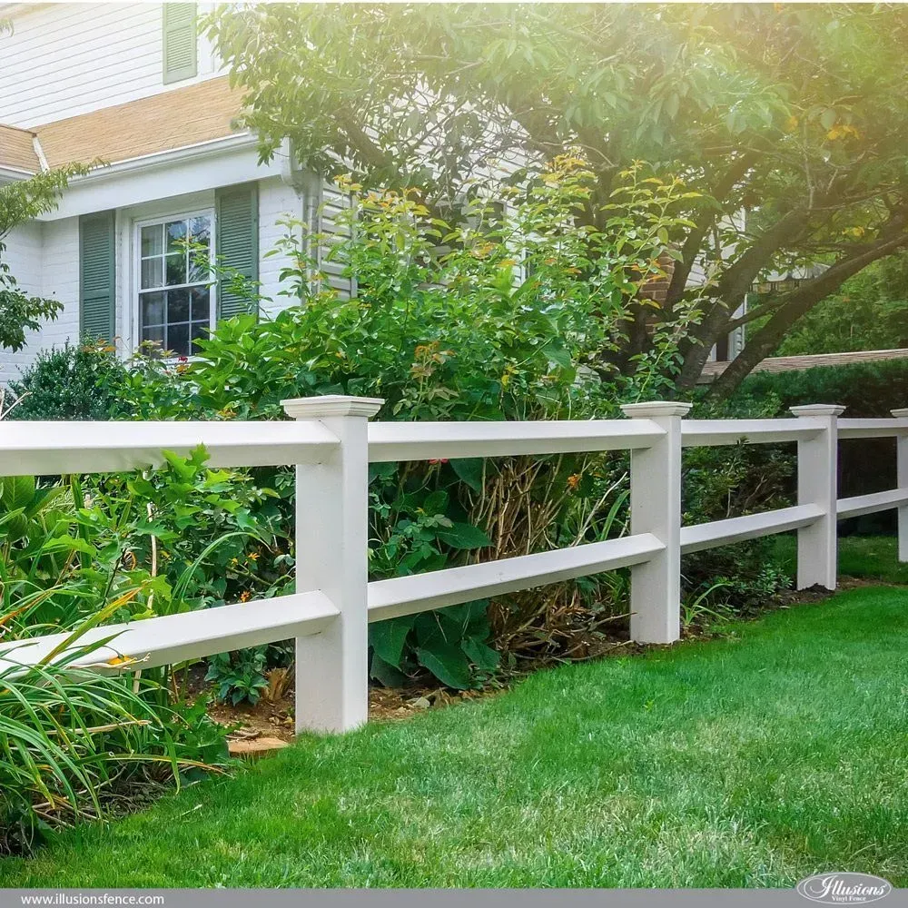 White picket fence borders a lush green yard in front of a house.