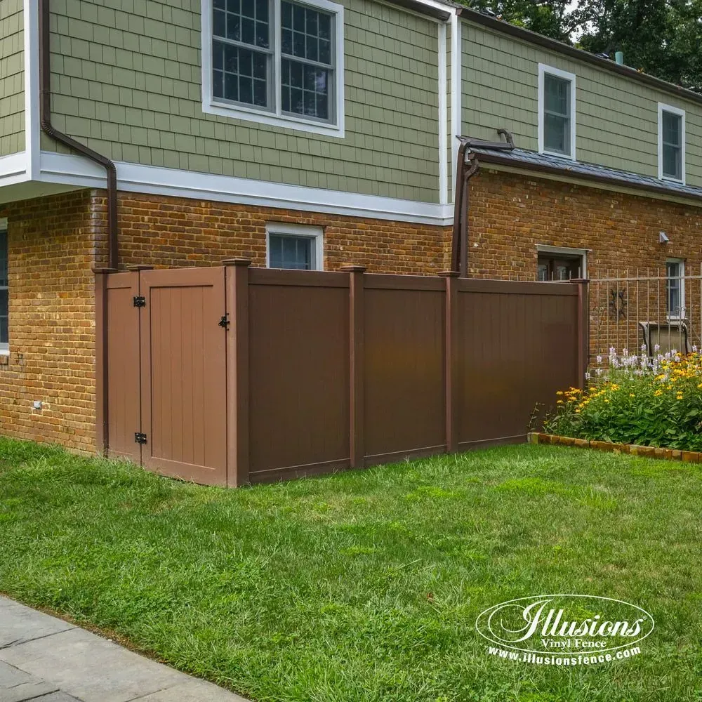 Brown vinyl privacy fence next to a brick and siding house with a gate.