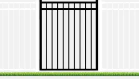 Black metal gate in a white fence. Green grass at the bottom.