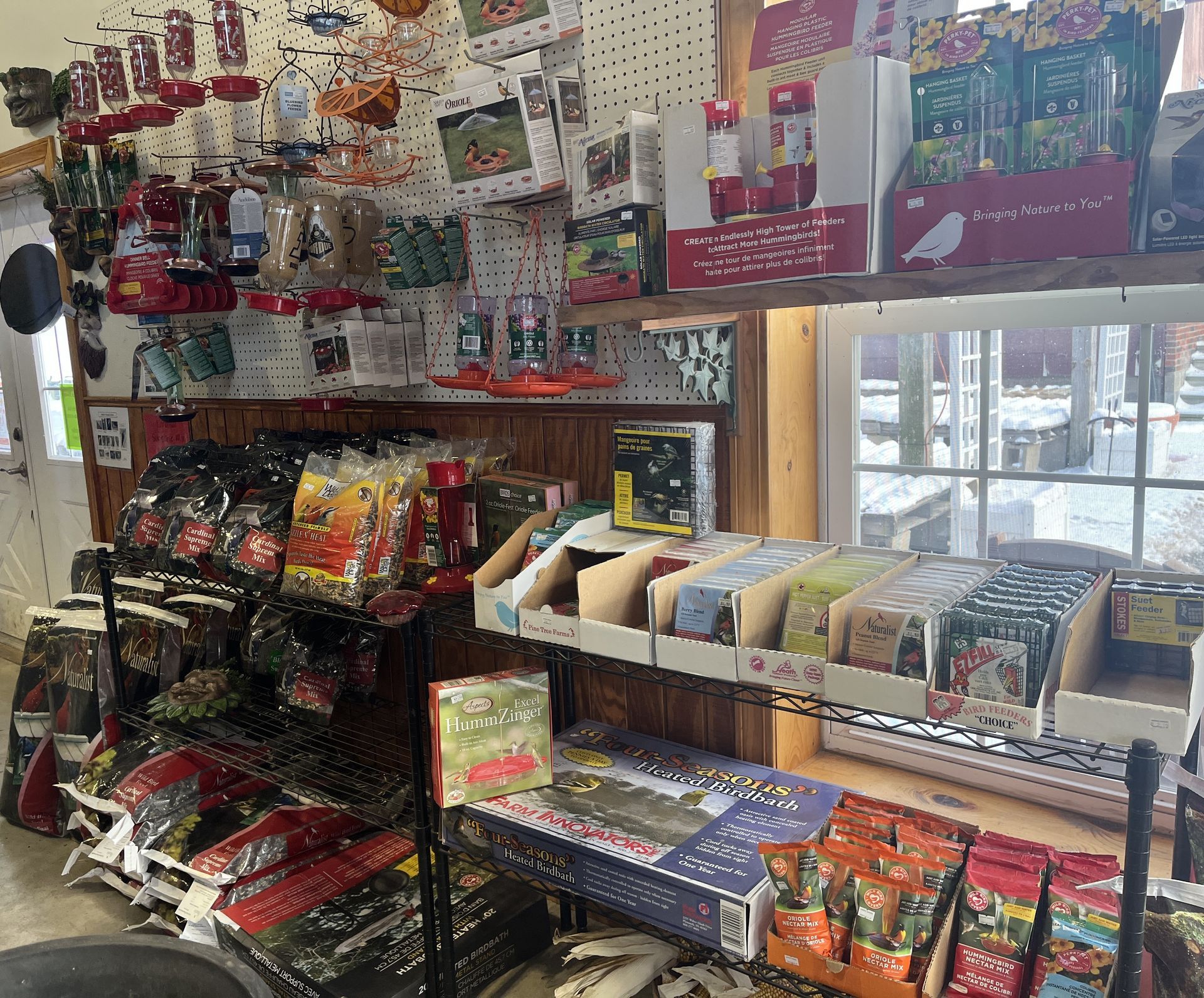 Inside a small shop: seeds, bird feeders, and other gardening supplies are on display.