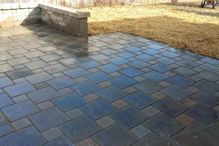 a paver patio with a bench