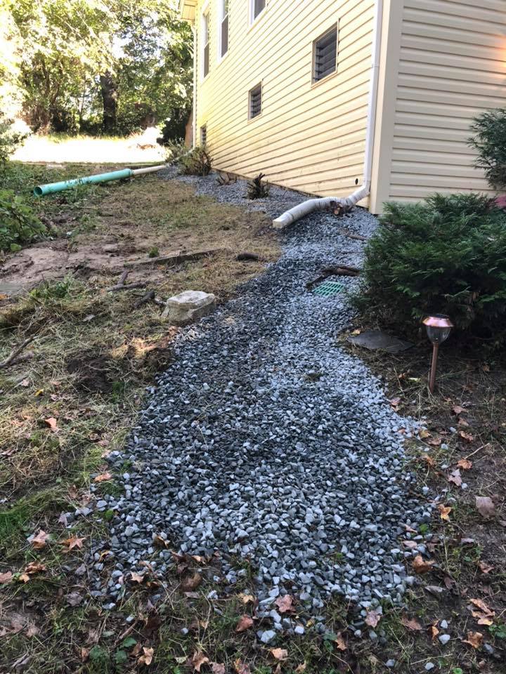 A gravel path leading to the side of a house.