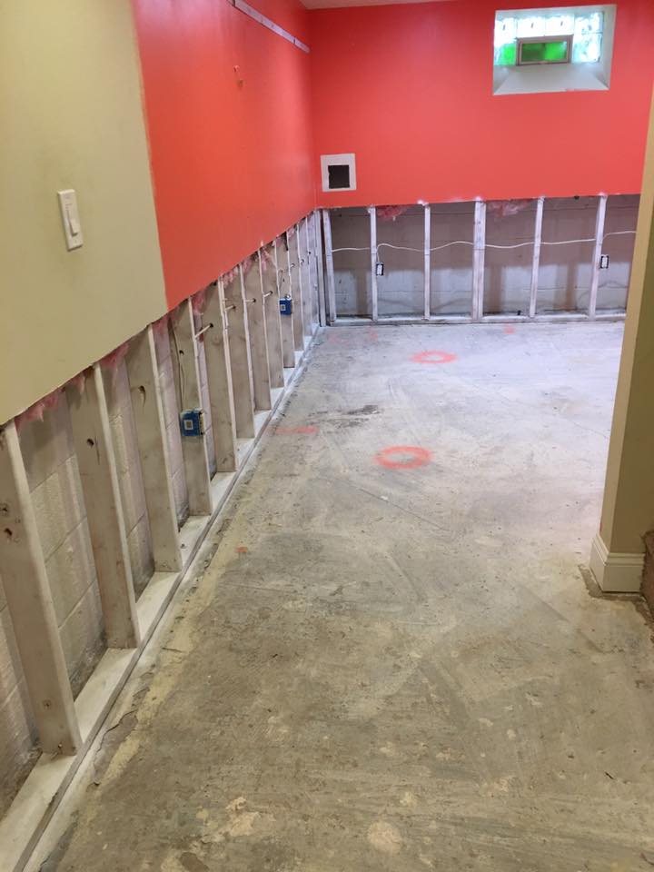 A room with red walls and a concrete floor