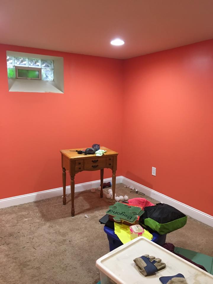 A room with red walls and a small window