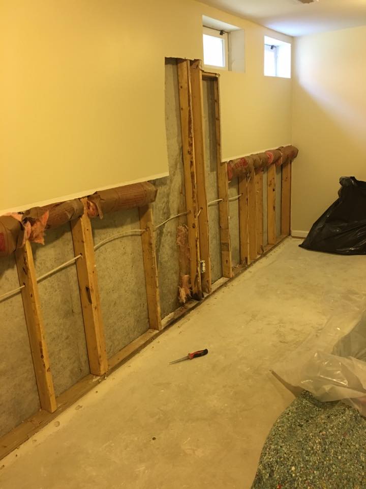 A room with a lot of wooden beams and a screwdriver on the floor