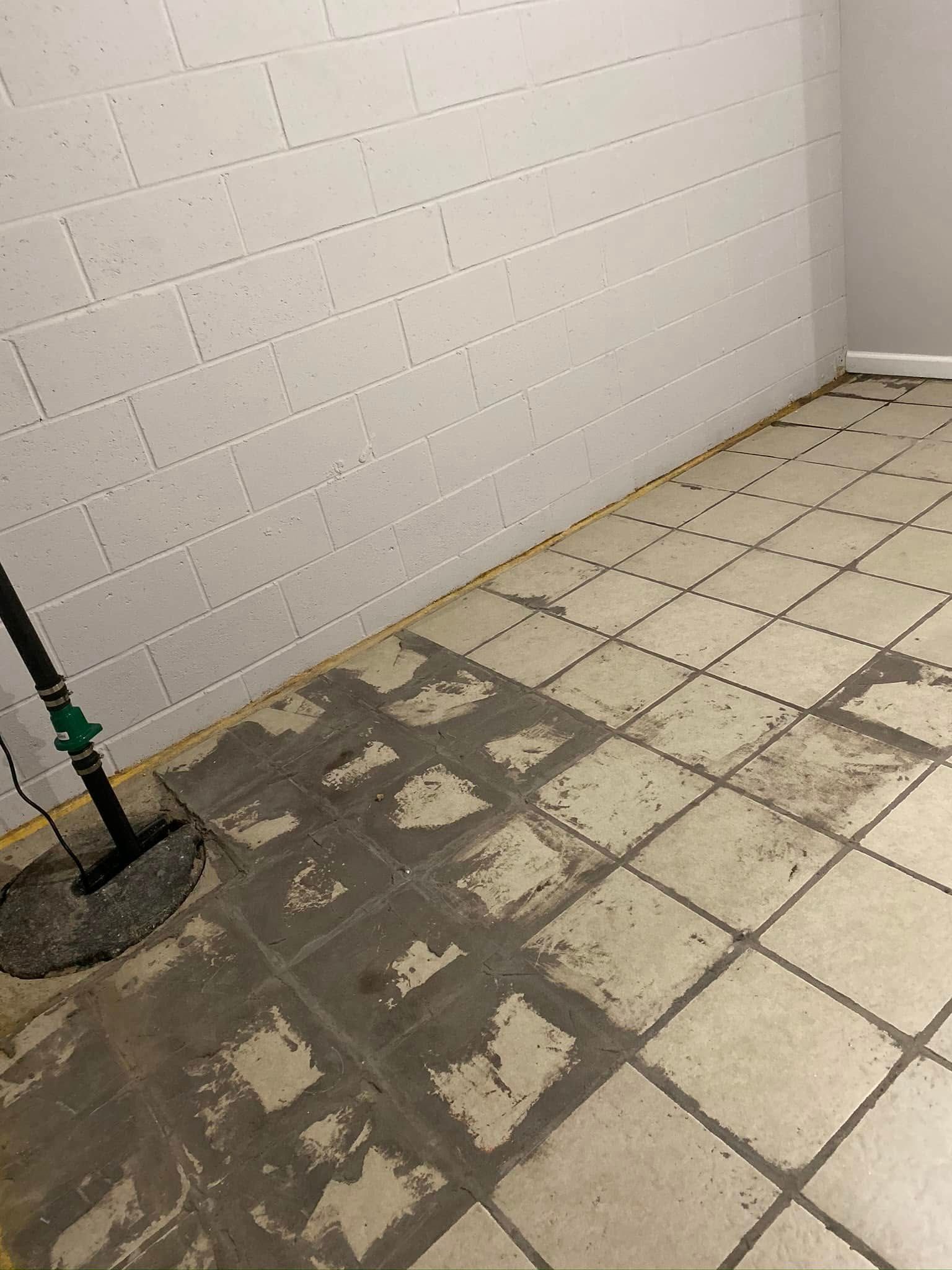 A room with a tiled floor and a brick wall.