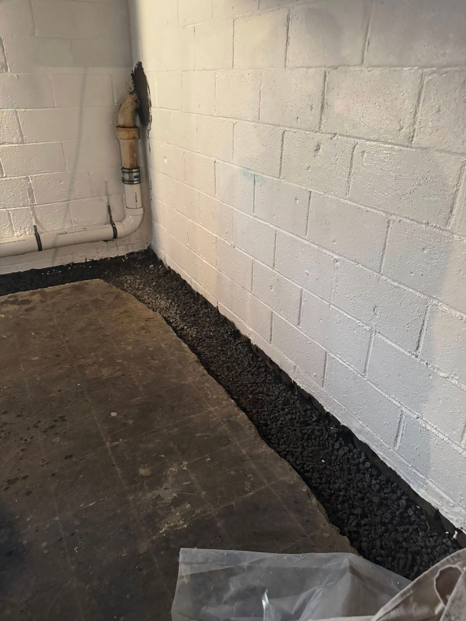 A room with a brick wall and a concrete floor.